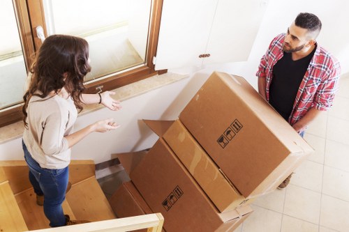 Unloading household items from a move van into a new home